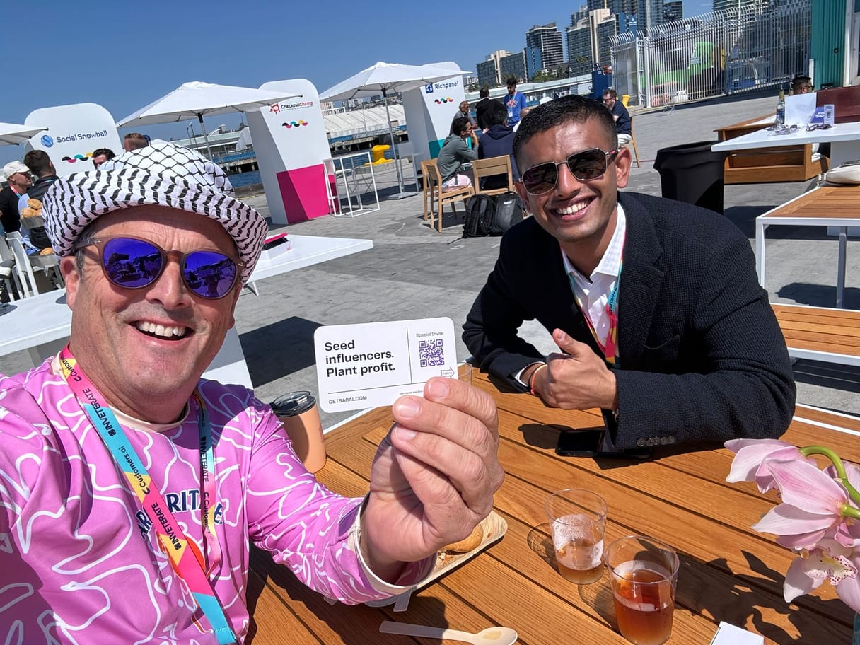 Picture of Yash Chavan with a customer holding SARAL's business card up